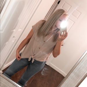 Tan button down top. Shorter in the front!